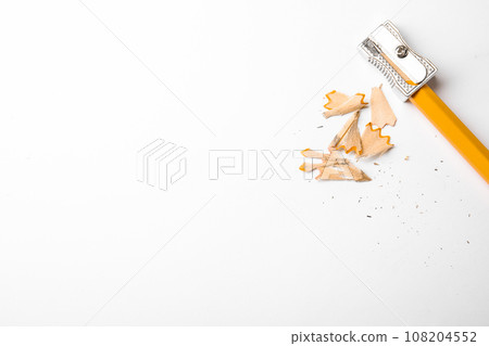 Graphite pencil, shavings and sharpener on white background, top view. Space for text 108204552