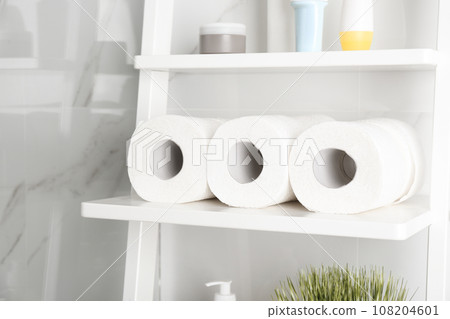 Toilet paper rolls on shelving unit in bathroom Toilet paper rolls on shelving unit in bathroom 108204601
