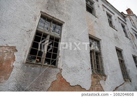 From below of abandoned building with broken glass windows and weathered wall during daytime From below of abandoned building with broken glass windows and weathered wall during daytime 108204608