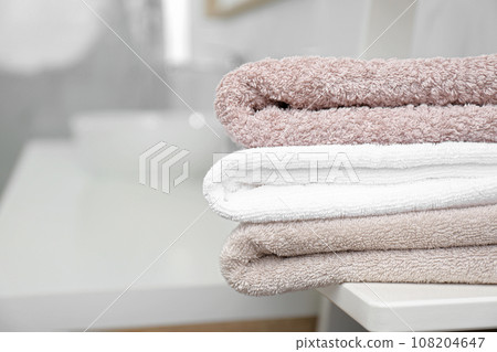 Fresh laundry on table in bathroom, closeup 108204647