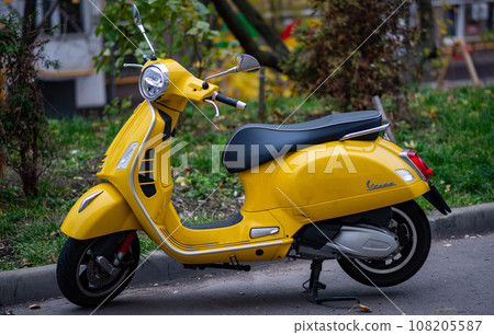 A yellow Vespa scooter in the courtyard of a residential building in the center of the Russian capital. A yellow Vespa scooter in the courtyard of a residential building in the center of the Russian capital. 108205587