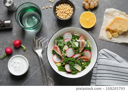 Tasty fresh kale salad on grey table, flat lay Tasty fresh kale salad on grey table, flat lay 108205793