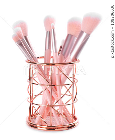 Set of professional makeup brushes in holder isolated on white 108206036