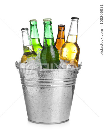 Beer in metal bucket with ice isolated on white Beer in metal bucket with ice isolated on white 108206051