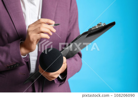 Professional journalist taking notes on light blue background, closeup Professional journalist taking notes on light blue background, closeup 108206090