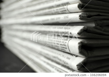 Stack of newspapers on table, closeup. Journalist's work Stack of newspapers on table, closeup. Journalist's work 108206094