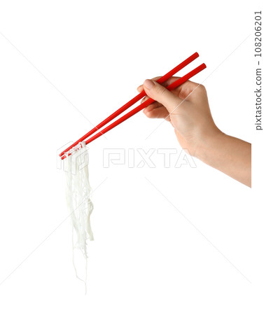 Woman holding chopsticks with tasty cooked rice noodles on white background, closeup 108206201