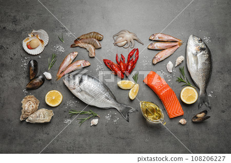 Fresh fish and seafood on grey table, flat lay Fresh fish and seafood on grey table, flat lay 108206227