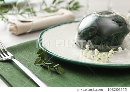 Stylish tableware with flowers on table, closeup. Festive setting 108206255