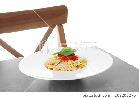 Delicious farfalle pasta with tomato sauce served on grey table 108206279