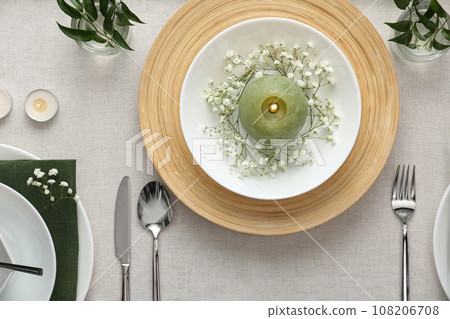 Elegant table setting with green plants on light cloth, flat lay 108206708