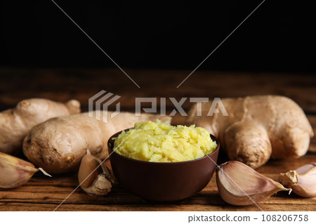 Fresh garlic and other natural cold remedies on wooden table 108206758