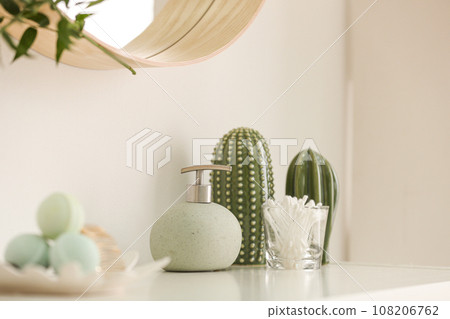 Dispenser and cotton swabs on white shelf in bathroom Dispenser and cotton swabs on white shelf in bathroom 108206762