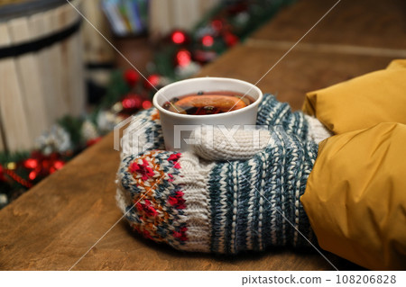Woman with cup of mulled wine at counter, closeup 108206828