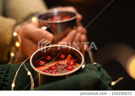 Couple with cups of tasty mulled wine, closeup Couple with cups of tasty mulled wine, closeup 108206833