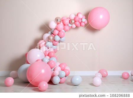Beautiful composition with balloons near beige wall 108206888