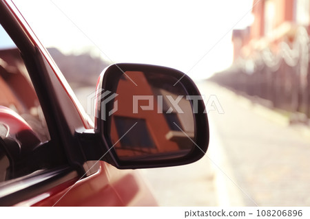 Side rear view mirror of modern car outdoors Side rear view mirror of modern car outdoors 108206896