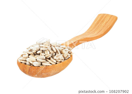 Peeled sunflower seeds in a wooden spoon isolated on white background. File contains clipping path. Peeled sunflower seeds in a wooden spoon isolated on white background. File contains clipping path. 108207902
