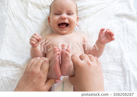 Playful interactions with baby's small feet. Concept of the joys of motherhood 108208287