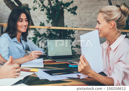 Young people discussing creative project on cafe terrace Young people discussing creative project on cafe terrace 108208612