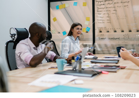 Excited employee discussing project with colleagues at workplace Excited employee discussing project with colleagues at workplace 108209023
