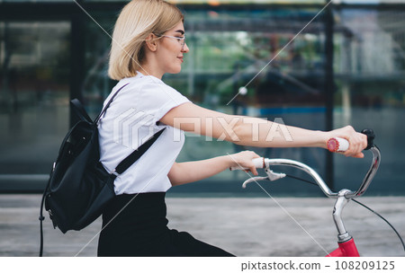 Female cyclist riding on street Female cyclist riding on street 108209125
