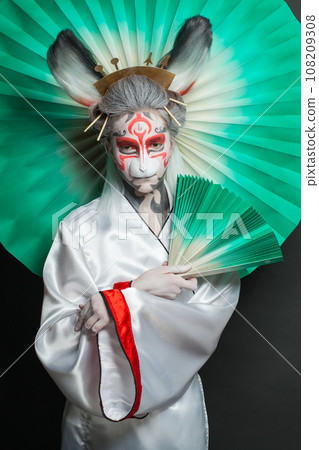 Nice fashion model young woman with creative makeup wearing Halloween or carnival costume posing  108209308