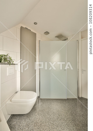 a modern bathroom with a toilet and shower stall in the corner next to the bathtub on the right side a modern bathroom with a toilet and shower stall in the corner next to the bathtub on the right side 108209314