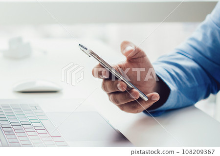 Crop businessman using mobile phone 108209367