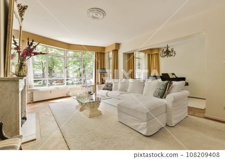 a living room with couches, coffee table, and fireplace in the middle part of the room is white 108209408