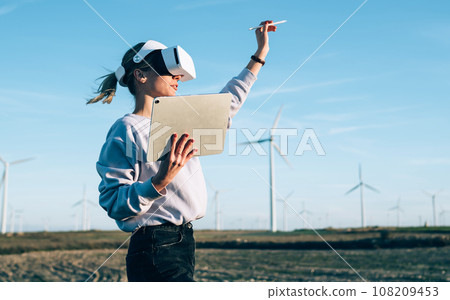 Woman creating virtual reality in open space Woman creating virtual reality in open space 108209453