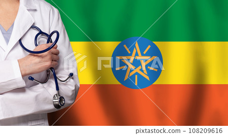 Ethiopian medicine and healthcare concept. Doctor close up against flag of Ethiopia background Ethiopian medicine and healthcare concept. Doctor close up against flag of Ethiopia background 108209616