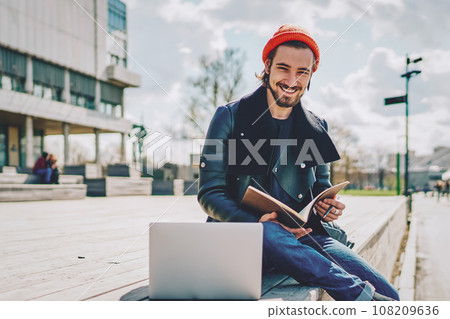 positive hipster guy with notepad 108209636