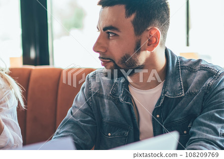 Chatting young colleagues sitting in cafe Chatting young colleagues sitting in cafe 108209769