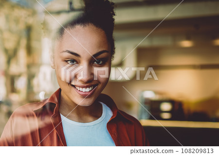 Portrait of happy female student spending time in coworking space 108209813