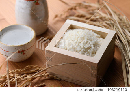 方形木紋背景中的熱清酒(白米)米 方形木紋背景中的熱清酒(白米)米 108210110