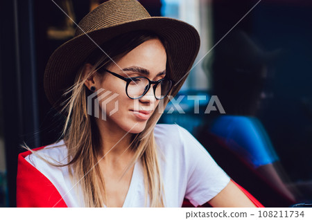 Trendy blogger typing on laptop at cafe table Trendy blogger typing on laptop at cafe table 108211734