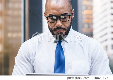 Confident bald and bearded African American entrepreneur in formal wear with tie Confident bald and bearded African American entrepreneur in formal wear with tie 108211752