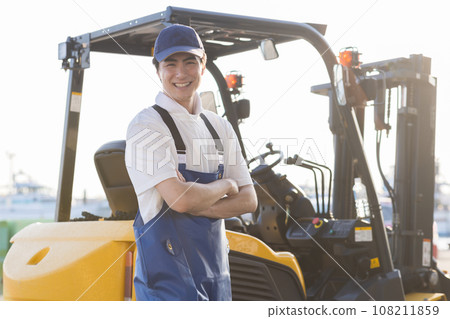 A young fisherman working at a fishing port 108211859