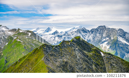 Majestic alpine panorama with glacier mountain of Grossvenediger. The main peak of the Venediger Group in Hohe Tauern mountain range. Austrian Alps, Austria. Majestic alpine panorama with glacier mountain of Grossvenediger. The main peak of the Venediger Group in Hohe Tauern mountain range. Austrian Alps, Austria. 108211876