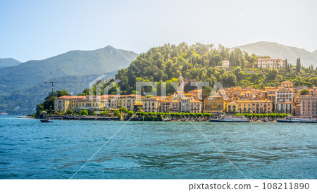 Bellagio town at Como Lake on sunny summer day. Idyllic view from ferry. Lombardy, Italy Bellagio town at Como Lake on sunny summer day. Idyllic view from ferry. Lombardy, Italy 108211890