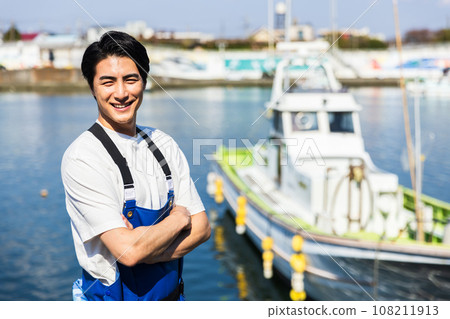 A young fisherman working at a fishing port A young fisherman working at a fishing port 108211913