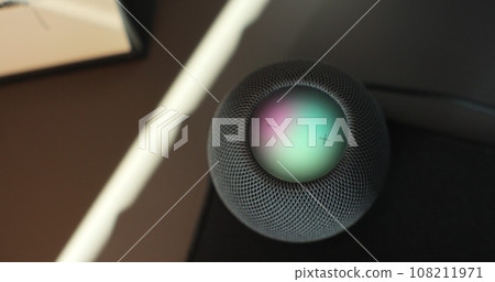 HomePod Mini speaker with assistant to play music, static on desk. Concept of a smart home. 108211971