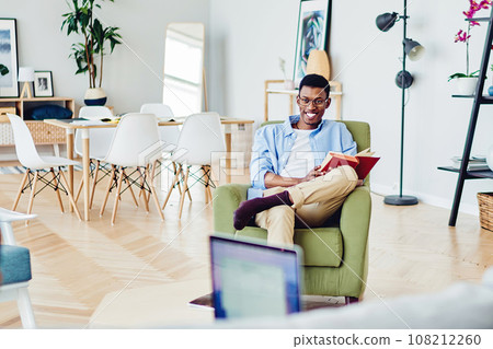 Happy african american hipster guy laughing having fun during free time at home with girlfriend Happy african american hipster guy laughing having fun during free time at home with girlfriend 108212260