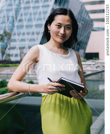 Confident Asian businesswoman with notepad 108212293