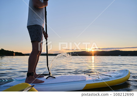 Male legs on a paddle board. 108212690