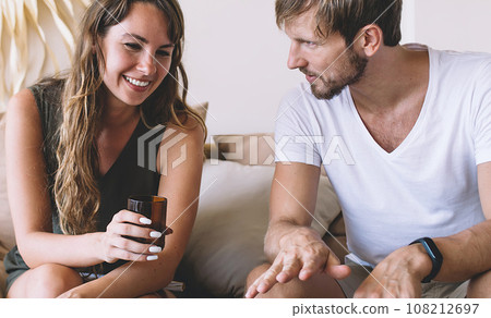 Joyful couple with laptop at home 108212697
