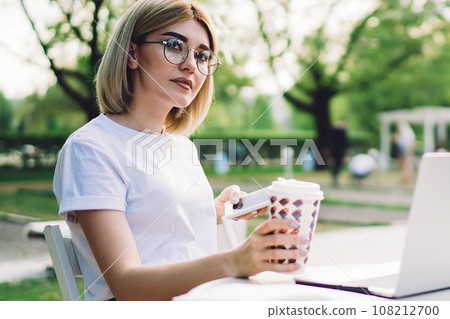 Attractive female freelancer during coffee break Attractive female freelancer during coffee break 108212700