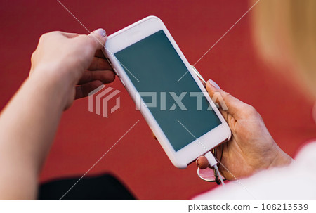 Anonymous woman messaging on smartphone Anonymous woman messaging on smartphone 108213539