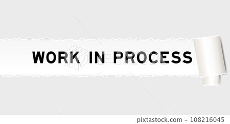 Ripped gray paper background that have word work in process under torn part 108216045